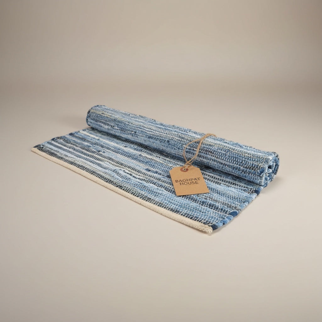 Baghpat House Kirsehir flat-woven jute rug in blue and white stripes, inspired by Anatolian kilim tradition.