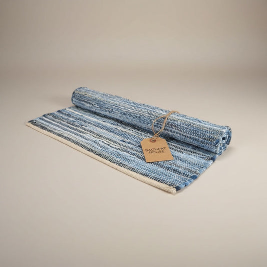 Baghpat House Kirsehir flat-woven jute rug in blue and white stripes, inspired by Anatolian kilim tradition.