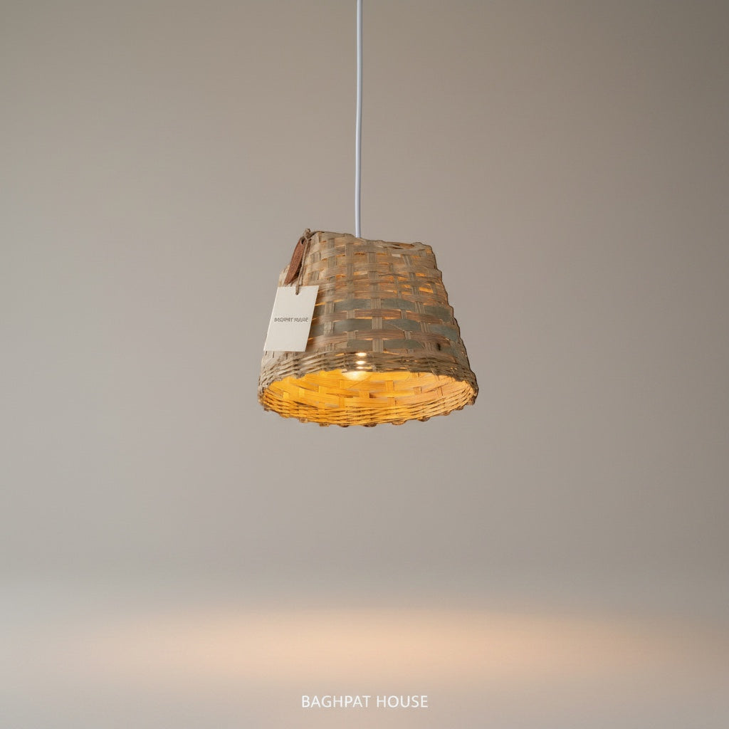 Baghpat House woven bamboo pendant light fixture with a natural, earthy tone and artisanal texture. Creates a warm ambiance.