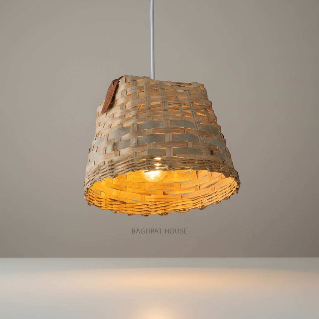 Baghpat House woven bamboo pendant light fixture with a natural, earthy tone and artisanal texture. Warm ambient light.